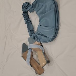 Gorgeous crossed two strapped blue shoes and purse